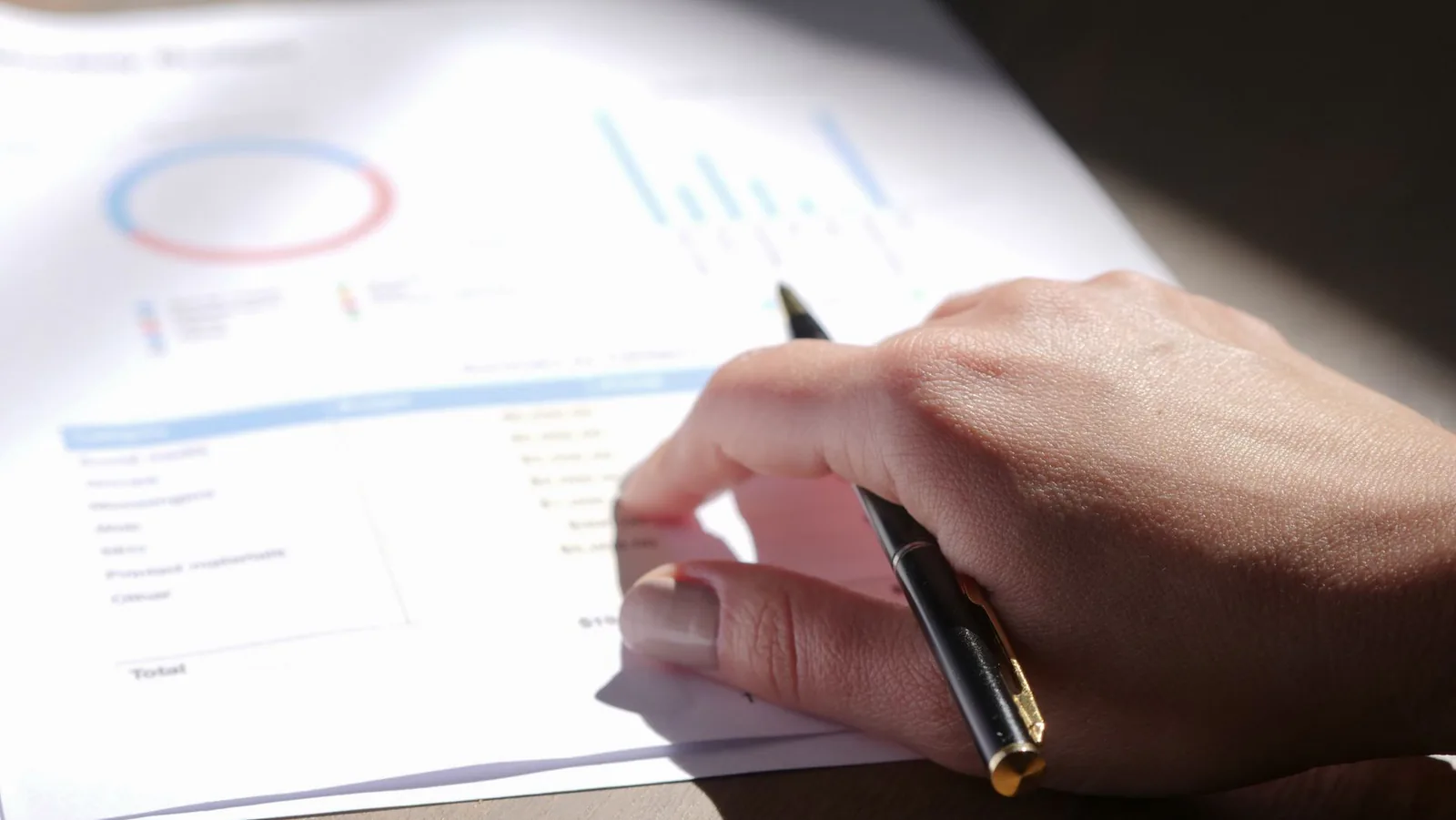 Reviewing compensation survey charts with a pen