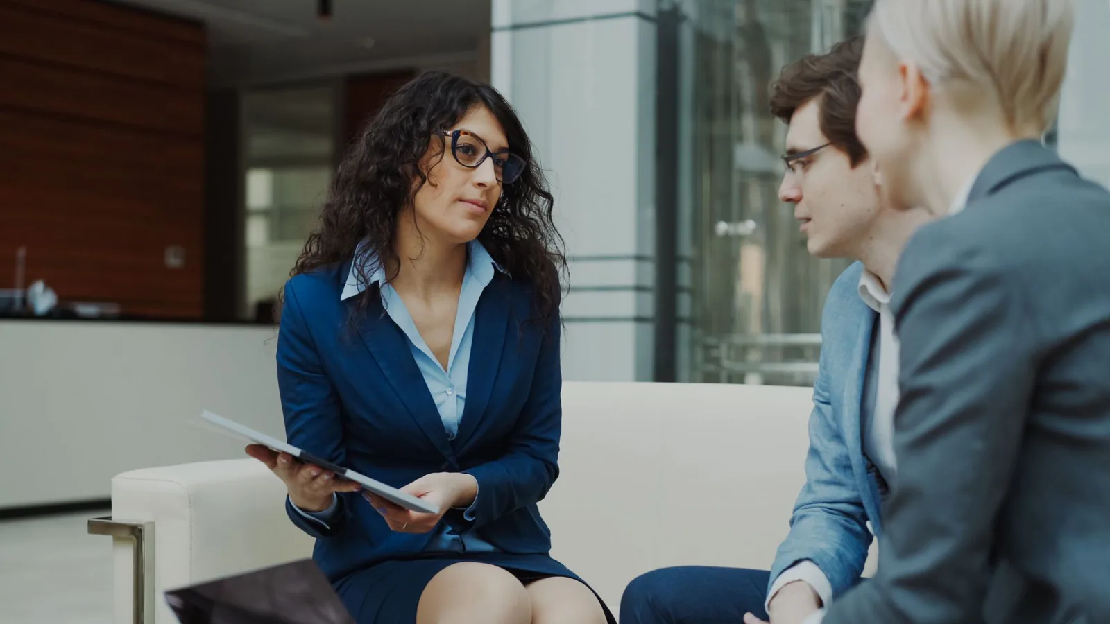 Advisors in a strategy meeting at a modern office table